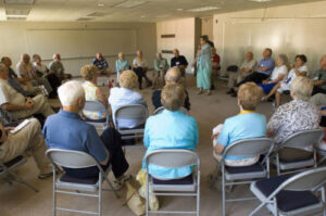 Members of the Class of 1951 seated in a circle at a forum in 2006
