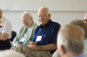 Two seated members of the Class of 1951 at a 2006 forum