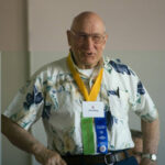 Member of the Class of 1951 standing at a 2006 forum