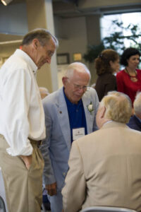 Three members of the Class of 1951 at a 2006 forum