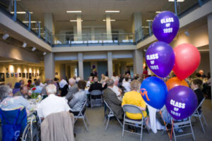 Balloons and members of the Class of 1951 seated at a dinner in 2006
