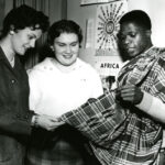 Students with Africa poster and fabric class of 1961