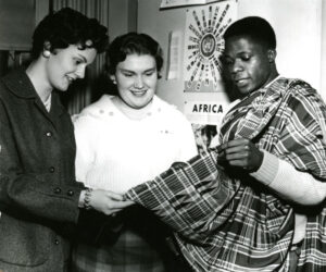 Students with Africa poster and fabric class of 1961