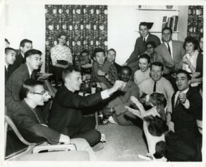International Center 1960 students playing with dog