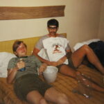 Dale Shuster and his roommate reclining on a bed