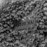 Photo of the Dayton Hall sign, surrounded by ivy
