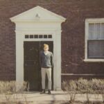 Photo of Don Hill standing in front of Kirk Hall