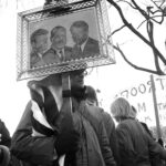 Protester carries portraits of JF Kennedy, ML King & RF Kennedy at March on Washington, November, 1969