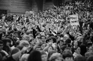 Large crowd of anti-war demonstrators inside at a Moratorium gathering 11/1969