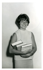 Portrait of Susan Virnig standing with books