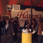 Students partying in tent with Hamm's truck