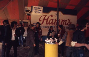 Students partying in tent with Hamm's truck