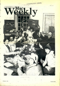Cover photo of students sitting at a large table toasting