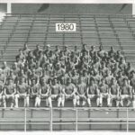 football players sitting in the bleachers for a team photo