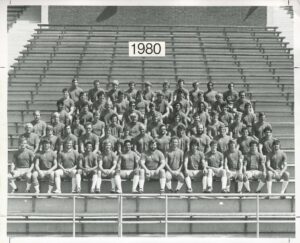 football players sitting in the bleachers for a team photo