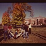 Color photo of stduents playing games on the lawn in the Fall