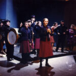 Performers in costume on stage in Happy End, Spring 1991