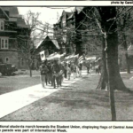 Mac Weekly 4/22/1988 photo of international students holding flags walking on the sidewalk, as part of International Week
