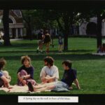 Students relaxing on the Old Main lawn, photo caption reads, "A Spring day on the mall in front of Old Main"