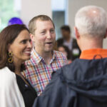 Two people talking to President Brian Rosenberg at Class of 1991 gathering at Reunion 2016