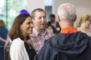 Two people talking to President Brian Rosenberg at Class of 1991 gathering at Reunion 2016