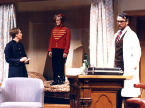 Three performers on stage in What the Butler Saw Spring 1988