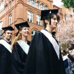 Three students in caps and gowns in procession at Commencement 1996