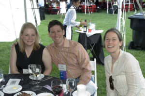 Three members of the Class of 1996 seated at a table at Reunion 2006