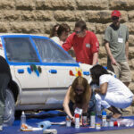 People painting an Art Car at Reunion 2006