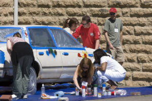 People painting an Art Car at Reunion 2006