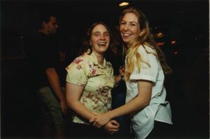 Two smiling members of the Class of 1996 gathering at O'Gara's at Reunion 2001