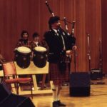 Bagpiper performing on stage, African Music Ensemble Spring 1994