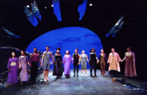 The cast from the production of Ophelias holding hands on stage