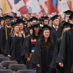 Students in line leaving the field house after commencement