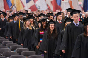 Students in line leaving the field house after commencement