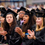 Students clapping and cheering during commencement