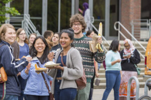 Happy students posing with their corn and plates of food