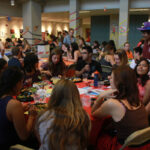 Students gathered at tables mingling and eating