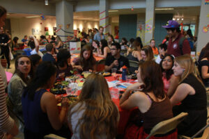 Students gathered at tables mingling and eating